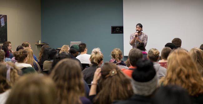 Poet, MC and teaching artist Myrlin Hepworth, a speaker in the Urban Education Speaker Series, talks to an engaged crowd at MSU in October 2015.