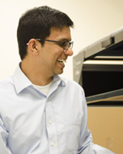 Dr. Rajiv Raganathan laughs describing one of the new machines in the labs.
