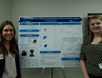 Emma Bizzigotti (left) and Brittany Ladson (right) present their poster, "It's Never Too Late to Learn: Differences in motor Skill Learning Between Children and Adults," at UURAF 2015. 