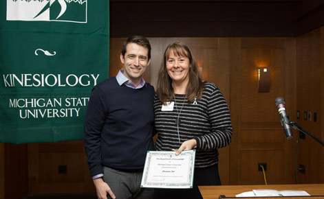 Hill poses with Associate Professor Karin Pfeiffer, who presented him with the award. 