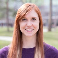 Liz Owens Boltz headshot. She is wearing a purple shirt. Her red hair is long and falls past her shoulders.