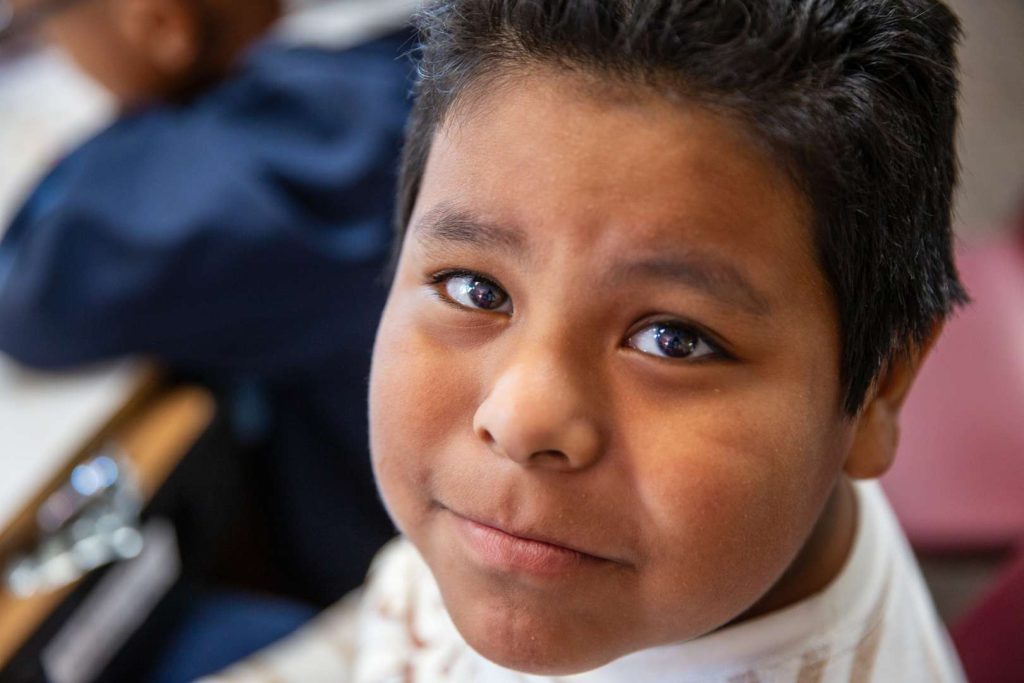 A student smiles at camera.