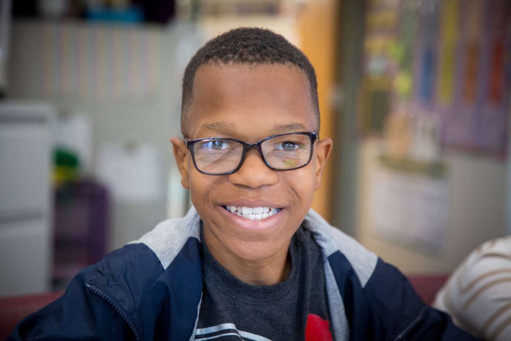 A student smiles at the camera.