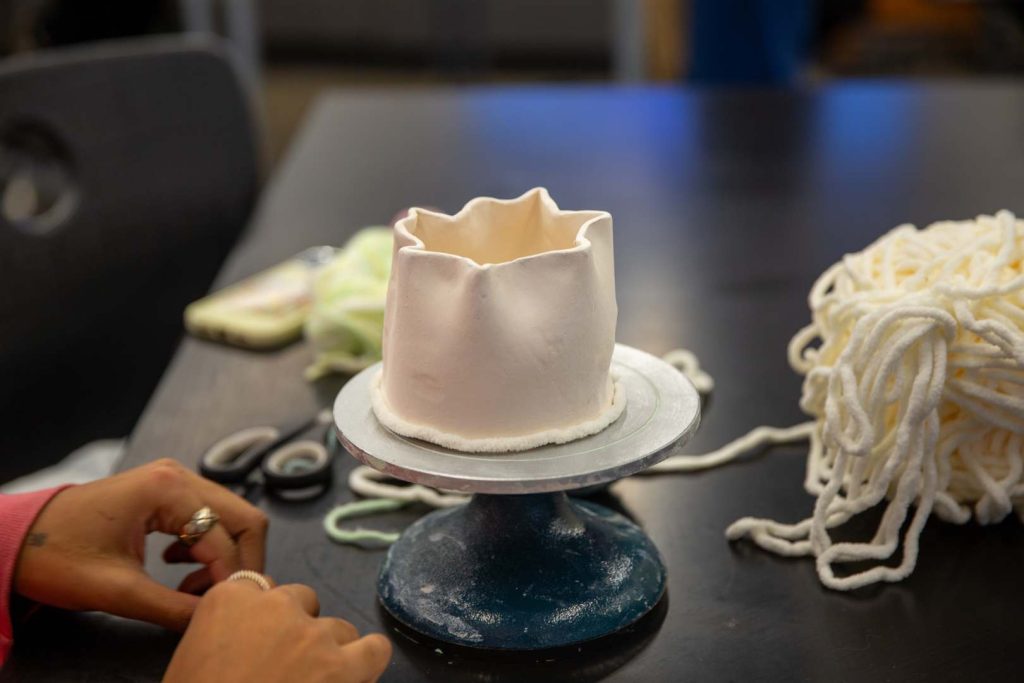 A piece of pottery sits on a student's desk.