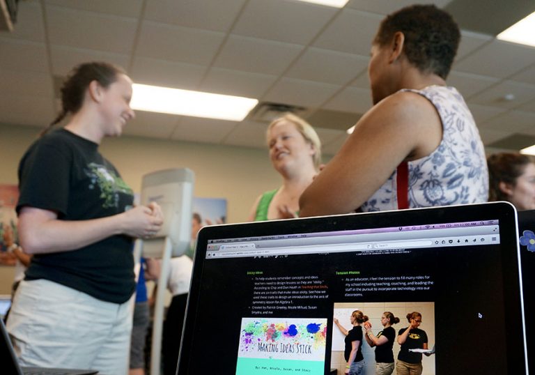 Laptop with smiling students