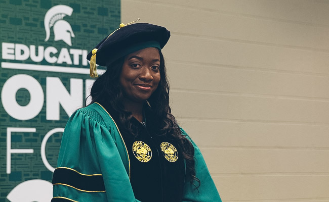 A Spring 2019 Doctoral Candidate takes stage to receive her honors.