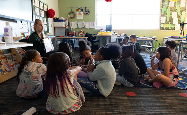 Spartan educator reads to her students in a Lansing-based classroom.