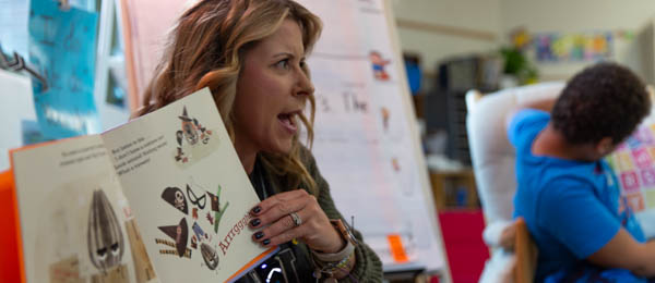 teacher showing story book