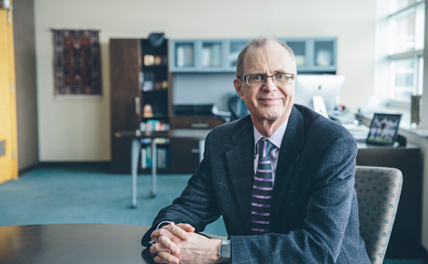 Dean Robert Floden seated in his office