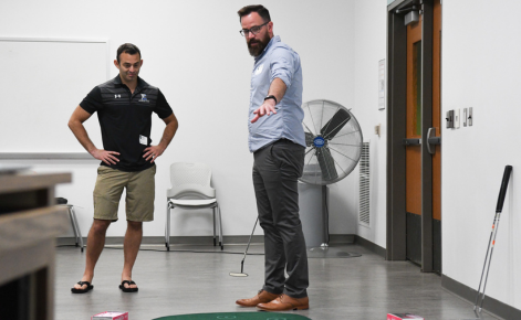 Assistant Professor Andy Driska leads an exercise during a Summer Coaches' School event