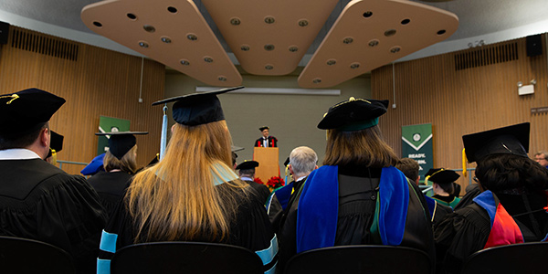 Graduates listen during a convocation ceremony